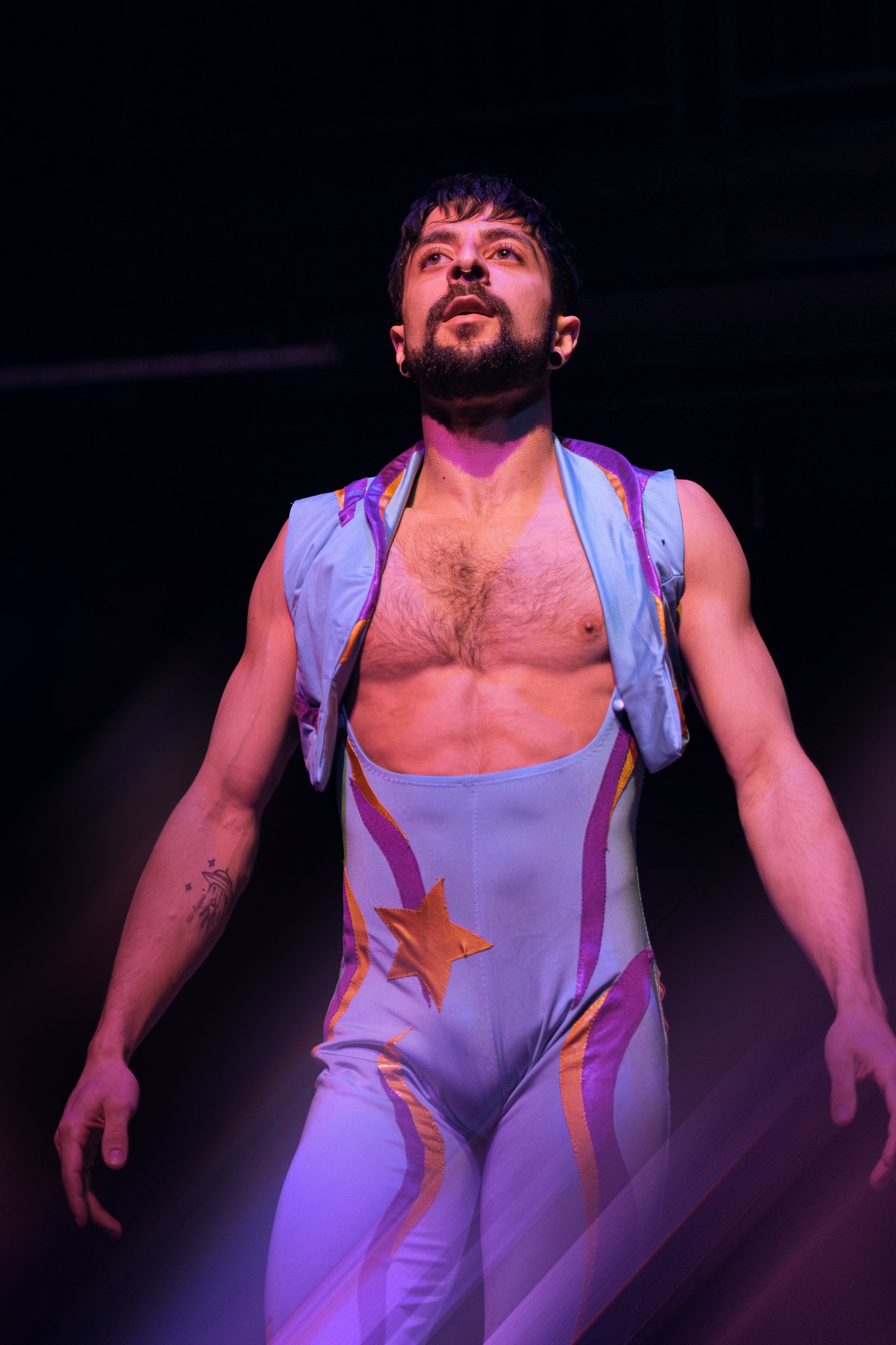 Hooman performing in vivid stage light