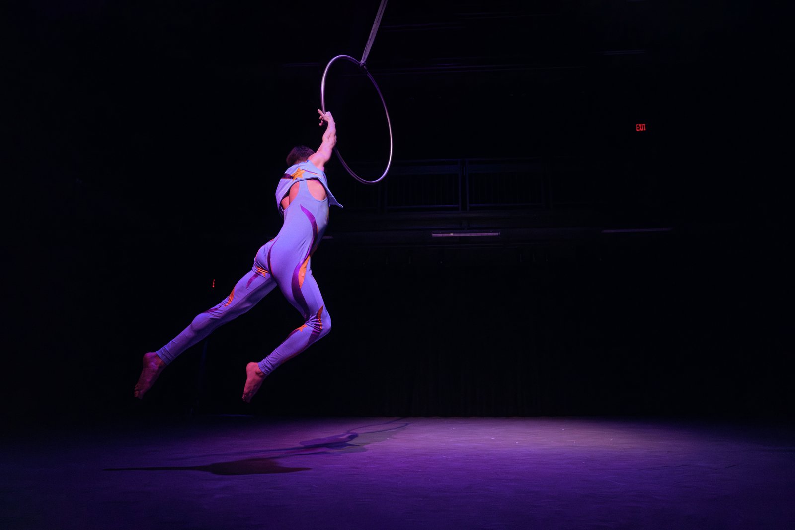 Hooman performing aerial hoop in black and white